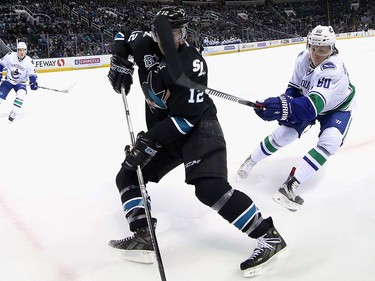 Markus Granlund #60 of the Vancouver Canucks and Patrick Marleau #12 of the San Jose Sharks go for the puck at SAP Center on March 31, 2016 in San Jose, California.  (Photo by Ezra Shaw/Getty Images)