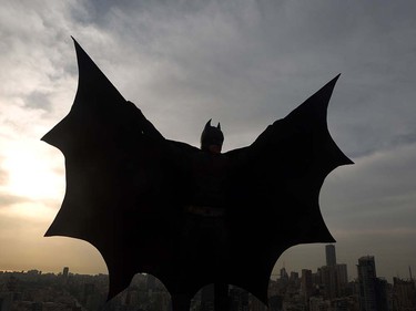 A Lebanese model dressed as Batman plays on the rooftop of a building during a photoshoot in the capital Beirut on March 23, 2016.  PATRICK BAZ/AFP/Getty Images