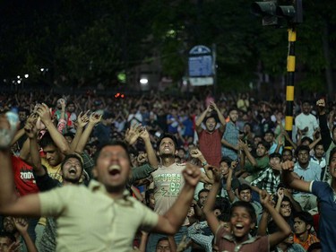 Bangladeshi cricket fan cheer their team as they watch the World T20 cricket tournament match between Bangladesh and India broadcast on a screen in a street in Dhaka on March 23, 2016. MUNIR UZ ZAMAN/AFP/Getty Images