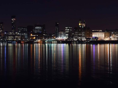 Lights illuminating the buildings lining the waterfront are reflected in the River Mersey in Liverpool, north west England on March 23, 2016. PAUL ELLIS/AFP/Getty Images