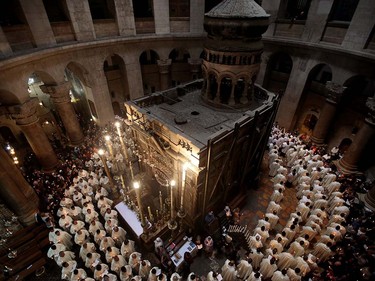 Roman Catholic clergymen hold candles as they circle the Aedicula during the Holy Thursday (Maundy Thursday) mass at the Church of the Holy Sepulchre in Jerusalem's Old City on March 24, 2016. GALI TIBBON/AFP/Getty Images