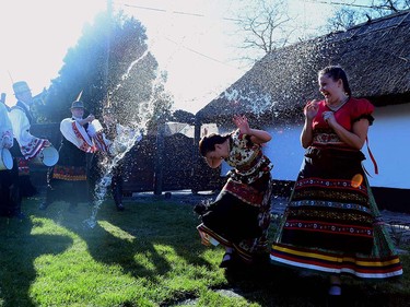 Dancers of 'Matyo Folklor Art Association'  in traditional clothes, react as boys throw water in Mezokovesd, some 130 km east of Budapest on March 24, 2016 during a rehearsal of the traditional Easter celebrations by the members of Mezokovesd folk dance group.  Locals from northeast Hungary celebrate Easter with the traditional "watering of the girls", a fertility ritual rooted in Hungary's tribal pre-Christian past, going as far back as the second century AD. ATTILA KISBENEDEK/AFP/Getty Images