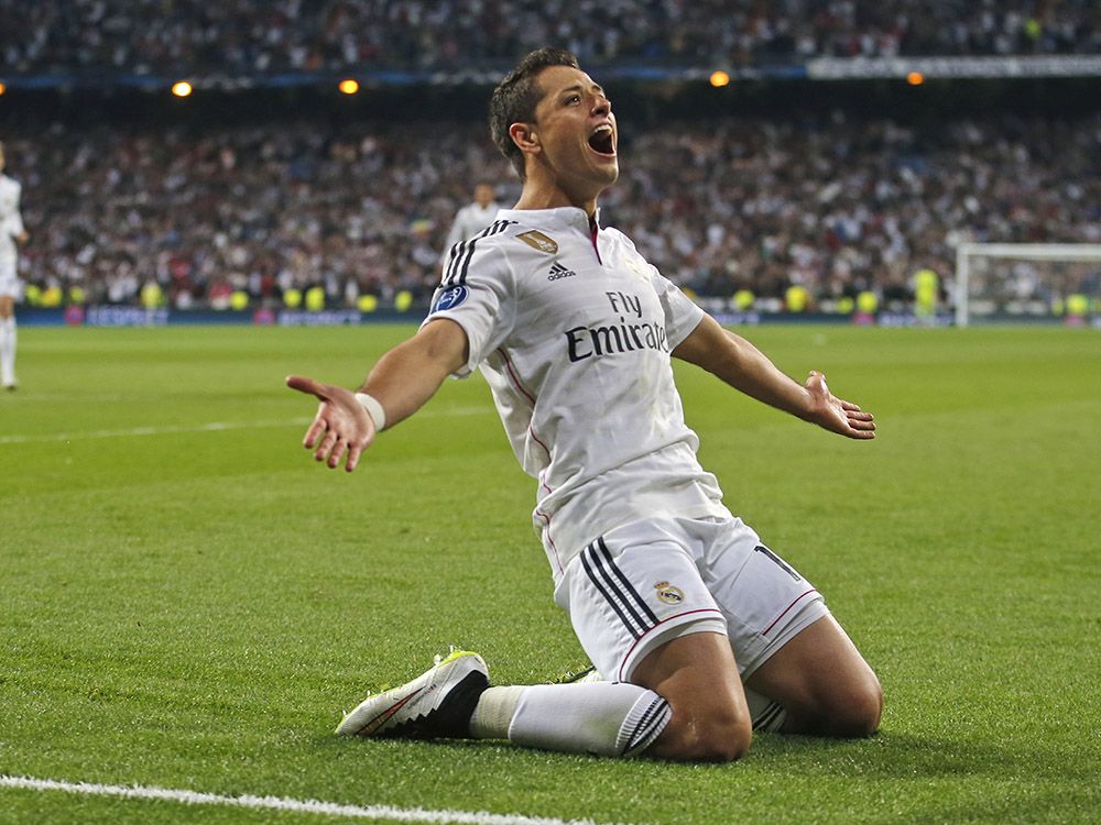 Real Madrid's Chicharito celebrates scoring his side's first goal during the second leg quarterfinal Champions League soccer match between Real Madrid and Atletico Madrid at Santiago Bernabeu stadium in Madrid, Spain, Wednesday April 22, 2015. (AP Photo/Paul White)