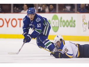 Vancouver Canucks' Bo Horvat (53) chases the puck against St. Louis Blues' Robby Fabbri (15) during first period NHL hockey action in Vancouver on Saturday, March 19, 2016.