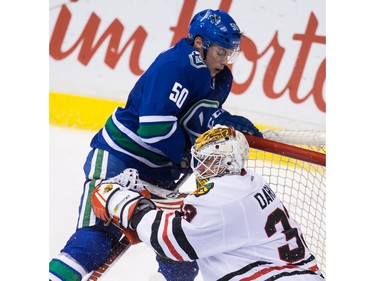 Vancouver Canucks' Brendan Gaunce (50) crashes into the net behind Chicago Blackhawks' goalie Scott Darling during the second period of an NHL hockey game in Vancouver, B.C., on Sunday March 27, 2016.
