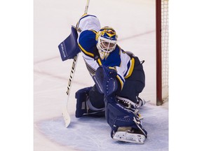 St. Louis Blues' goalie Brian Elliott makes a save against the Vancouver Canucks during second period NHL hockey action in Vancouver on Saturday, March 19, 2016.