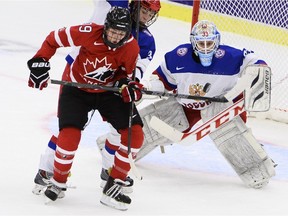 Emily Clark, left, battles for position in Canada's Group A game against Russia at the 2015 women's world championship tournament in Malmo, Sweden.