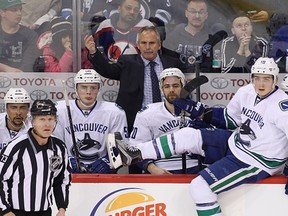 Willie Desjardins, head coach of the Vancouver Canucks, gestures from the bench in third period action in an NHL game against the Winnipeg Jets at the MTS Centre on March 22, 2016 in Winnipeg, Manitoba, Canada. (Photo by Marianne Helm/Getty Images)