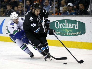 Vancouver Canucks right wing Linden Vey (7) reaches for the puck against San Jose Sharks defenseman Roman Polak (46) during the second period of an NHL hockey game Thursday, March 31, 2016, in San Jose, Calif. (AP Photo/Tony Avelar)
