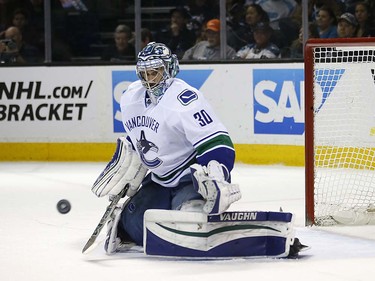 Vancouver Canucks goalie Ryan Miller (30) blocks a shot from San Jose Sharks during the first period of an NHL hockey game Thursday, March 31, 2016, in San Jose, Calif. (AP Photo/Tony Avelar)