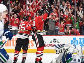 Bryan Bickell #29 of the Chicago Blackhawks reacts after the Blackhawks scored against the Vancouver Canucks in the third period of the NHL game at the United Center on December 13, 2015 in Chicago, Illinois.  (Photo by Bill Smith/NHLI via Getty Images)