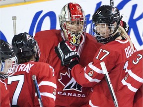 Charline Labonte, centre, is congratulated by teammates after an 8-1 win over Russia on Tuesday.