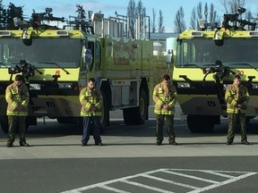 Firefighters and personnel at 19 Wing Comox air base bow their heads Sunday to remember Cpl. Christopher Stacey. Photo credit: Chris Helgren