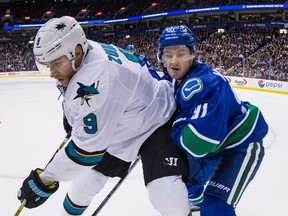 Vancouver Canucks forward Jared McCann (right) checks San Jose Shark Dainius Zubrus, during their NHL game at Rogers Arena earlier this month.