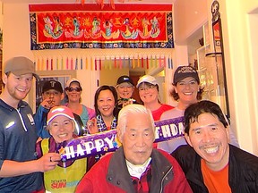 Frank Pan, lower right, poses for pictures with birthday boy/father-in-law David Hsu who turned 100 on March 24. Pan's Sun Run InTraining group paid the centenarian a special visit on Easter Sunday during their Week 11 workout.