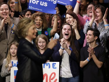 Supporters of Democratic presidential candidate Hillary Clinton react as she arrives for a rally at the Apollo Theater in New York, Wednesday, March 30, 2016.