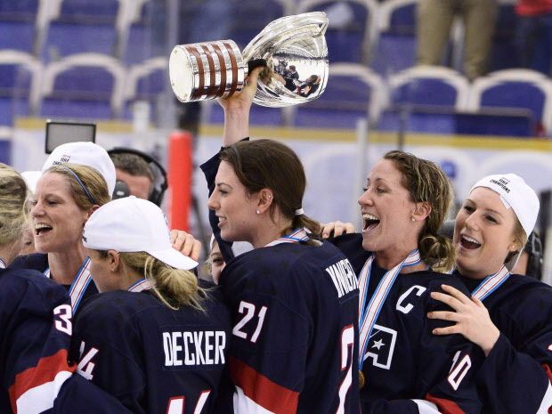 Team USA players including Hilary Knight, center, Meghan Duggan, second right, and Brianna Decker jubilate with the World Cup trophy after the 2015 IIHF Ice Hockey Women's World Championship final between U.S. and Canada at Malmo Isstadion in Malmo, southern Sweden, on Saturday April 4, 2015. (THE CANADIAN PRESS/AP/Claudio Bresciani)