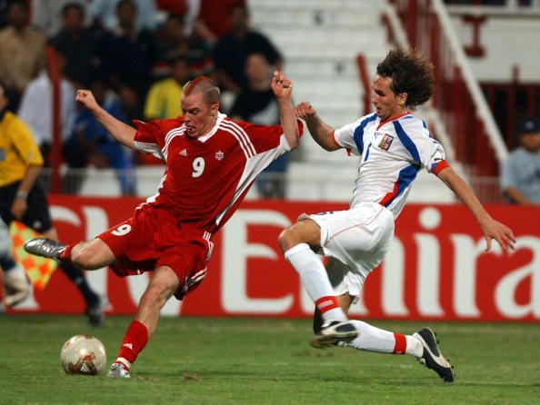 Canadian Iain Hume (L) reaches the ball before Czech Republic's Tomas Sivok during their FIFA World Youth Championship Group C match in Dubai in 2003. Canada won 1-0. (AFP PHOTO/MOHAMMED MAHJOUB) 