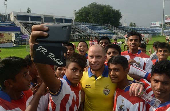 Iain Hume (C) poses for selfie with junior football players at Kanchajungha Stadium in Siliguri on September 26, 2015. (Diptendu DUTTA /AFP/Getty Images)