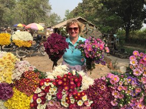 Loraine Whysall at flower stalls on the road to Pyin Oo Lwin