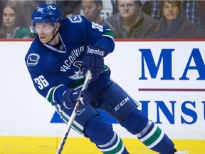 Vancouver Canucks' Jannik Hansen, of Denmark, skates with the puck during the during first period NHL hockey action against the San Jose Sharks, in Vancouver on Sunday, Feb. 28, 2016.