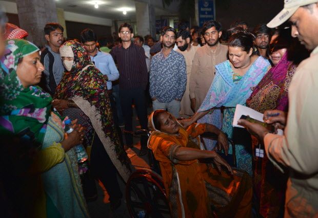 Pakistani relatives of injured victims gather outside the hospital in Lahore. (ARIF ALI/AFP/Getty Images)