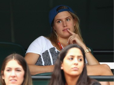 Eugenie Bouchard of Canada watches Grigor Dimitrov of Bulgaria playing against Andy Murray of Great Britain in their third round match during the Miami Open Presented by Itau at Crandon Park Tennis Center on March 28, 2016 in Key Biscayne, Florida.
