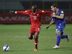 Canada's Atiba Hutchinson, left, vies for the ball with El Salvador's Pablo Punyed during a 2018 World Cup qualifying soccer match in San Salvador, El Salvador, on Nov. 17, 2015.