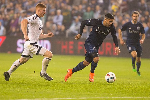 Dom Dwyer #14 of Sporting Kansas City drives past Tim Parker #26 of Vancouver Whitecaps in the second half on March 12, 2016 at Children's Mercy Park in Kansas City, Kansas. (Photo by Kyle Rivas/Getty Images)