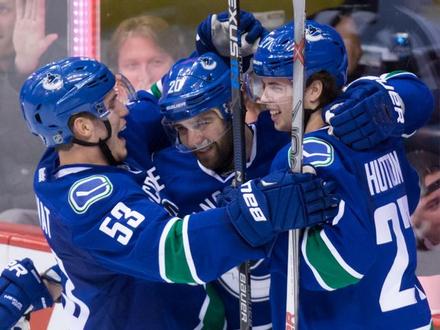 Vancouver Canucks' Bo Horvat, from left, Chris Higgins and Ben Hutton celebrate Higgins' goal against the San Jose Sharks during the second period of an NHL hockey game in Vancouver, B.C., on Tuesday March 29, 2016. (THE CANADIAN PRESS/Darryl Dyck)