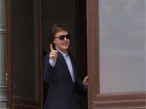 Sir Paul McCartney waves as he arrives at   Stella McCartney's Fall-Winter 2016-2017 ready to wear fashion collection presented Monday, March 7, 2016 in Paris.