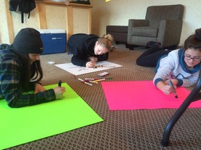 Students making posters ahead of their protest. (Submitted photo)