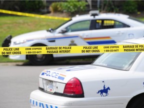 Archive image of Surrey RCMP cars behind police tape.