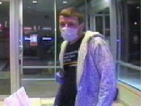 This surveillance photo from June 2013 shows the Surgical Mask Bandit in action. Travis Jensen-Pickford, 25, pleaded guilty to 12 robberies committed over a four-week period in 2013 that targeted people using ATMs.