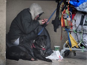 Homeless man with a dog in downtown Vancouver.