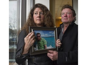 Margie and Mark Gray hold a picture of their son Myles Gray, who was killed by VPD in 2015 during a violent scuffle.