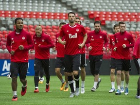 Team Canada, led by birthday-boy captain Julian de Guzman (far left) and Steven Vitria (centre) at practice this week, will have their hands full with CONCACAF powerhouse Mexico at BC Place Stadium on Friday.