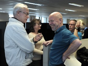 Long-time Vancouver Sun sports reporters Brad Ziemer, left, and Gary Kingston reminisce during their final day in the office at The Vancouver Sun on Thursday, March 31, 2016.
