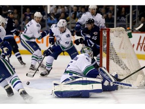 Vancouver Canucks goalie Jacob Markstrom is out of position after stopping Winnipeg Jets Nic Petan, not pictured, at the side of the net during second-period action in Winnipeg, on Tuesday.