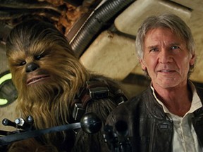 This photo provided by Lucasfilm shows Peter Mayhew as Chewbacca and Harrison Ford as Han Solo in "Star Wars: The Force Awakens."