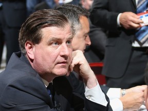 Canucks GM Jim Benning waits for the start of the first round of the 2014 NHL draft in Philadelphia.