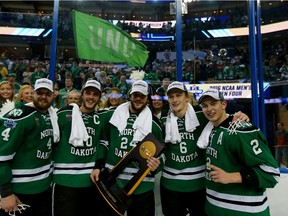 Defenceman Troy Stecher (far right) of the University of North Dakota Fighting Hawks was signed Wednesday by the Vancouver Canucks. Pictured with Stecher last weekend (from left) are teammates Keaton Thompson,Gage Ausmus, Christian Wolanin and Paul LaDue, after the Hawks won the NCAA men’s hockey championship over the Quinnipiac Bobcats.