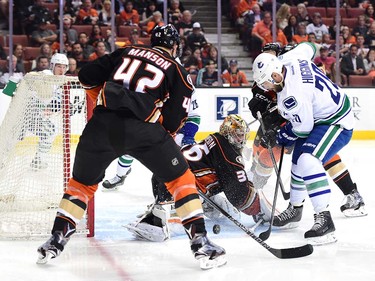 ANAHEIM, CA - APRIL 01:  John Gibson #36 of the Anaheim Ducks makes a save on Chris Higgins #20 of the Vancouver Canucks as Josh Manson #42 looks to clear a rebound during the second period at Honda Center on April 1, 2016 in Anaheim, California.  (Photo by Harry How/Getty Images)