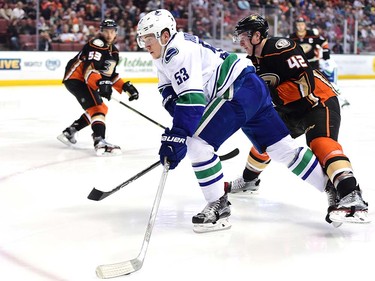 ANAHEIM, CA - APRIL 01:  Bo Horvat #53 of the Vancouver Canucks fends off Josh Manson #42 of the Anaheim Ducks on the way to the net during the second period at Honda Center on April 1, 2016 in Anaheim, California.  (Photo by Harry How/Getty Images)