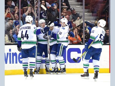 ANAHEIM, CA - APRIL 01:  Emerson Etem #26 of the Vancouver Canucks celebrates his goal with Bo Horvat #53 and Brendan Gaunce #50 to take a 3-2 lead over the Anaheim Ducks during the third period at Honda Center on April 1, 2016 in Anaheim, California.  (Photo by Harry How/Getty Images)