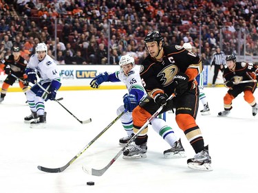 ANAHEIM, CA - APRIL 01:  Ryan Getzlaf #15 of the Anaheim Ducks breaks in on Alex Biega #55 of the Vancouver Canucks during the third period of a 3-2 Ducks loss at Honda Center on April 1, 2016 in Anaheim, California.  (Photo by Harry How/Getty Images)