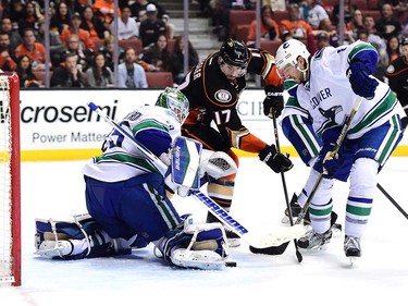 ANAHEIM, CA - APRIL 01:  Ryan Kesler #17 of the Anaheim Ducks looks for a rebound with Chris Tanev #8 of the Vancouver Canucks after a save by Jacob Markstrom #25 during the third period of a 3-2 canucks win at Honda Center on April 1, 2016 in Anaheim, California.  (Photo by Harry How/Getty Images)