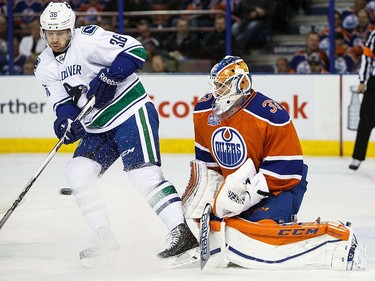 Goaltender Cam Talbot of the Edmonton Oilers defends the net against Jannik Hansen #36 of the Vancouver Canucks on April 6, 2016 at Rexall Place in Edmonton, Alberta, Canada. The game is the final game the Oilers will play at Rexall Place before moving to Rogers Place next season. (Photo by Codie McLachlan/Getty Images)