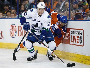 Andrej Sekera #2 of the Edmonton Oilers slams into the boards while defending against Brendan Gaunce #50 of the Vancouver Canucks on April 6, 2016 at Rexall Place in Edmonton, Alberta, Canada. The game is the final game the Oilers will play at Rexall Place before moving to Rogers Place next season. (Photo by Codie McLachlan/Getty Images)