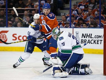 Connor McDavid #97 of the Edmonton Oilers can't get a shot past goaltender Jacob Markstrom #25 of the Vancouver Canucks on April 6, 2016 at Rexall Place in Edmonton, Alberta, Canada. The game is the final game the Oilers will play at Rexall Place before moving to Rogers Place next season. (Photo by Codie McLachlan/Getty Images)